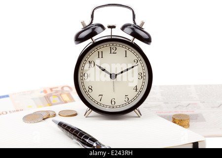 Business photo: alarm clock with fresh newspaper and open note book isolated on white background Stock Photo