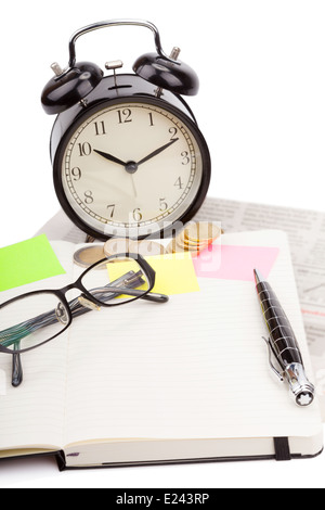 Business photo: alarm clock with fresh newspaper and open note book isolated on white background Stock Photo