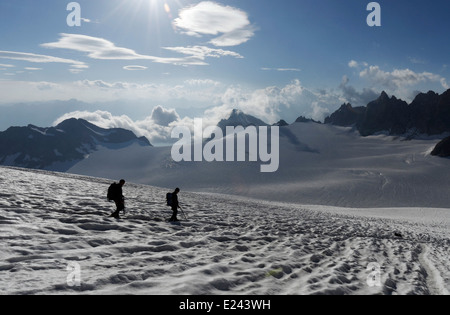 Two climbers on the Trient glacier in the French Alps with the Aiguilles Dorées beyond Stock Photo