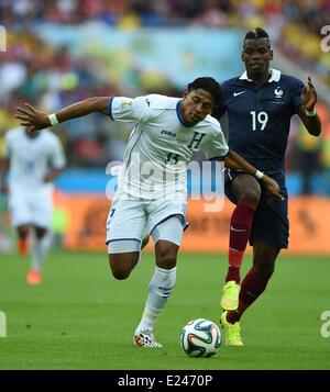 Porto Alegre, Brazil. 15th June, 2014. Frances Paul Pogba (R) challenges with Honduras Carlo Costly during a Group E match between France and Honduras of 2014 FIFA World Cup at the Estadio Beira-Rio Stadium in Porto Alegre, Brazil, June 15, 2014. Credit:  Action Plus Sports/Alamy Live News Stock Photo