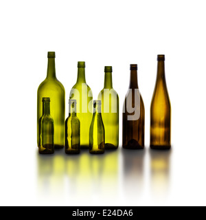 Empty glass wine bottles on white background with reflection. Bottles in various shapes and sizes. Stock Photo
