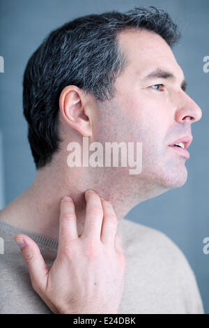 Itching in a man Stock Photo