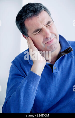 Ear pain in a man Stock Photo