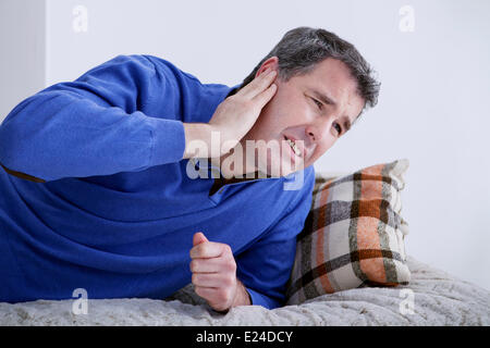 Ear pain in a man Stock Photo