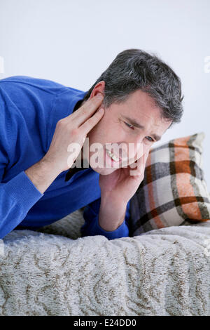 Ear pain in a man Stock Photo