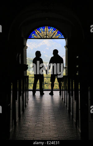 Silhouette of a gay couple to the output of church. Stock Photo