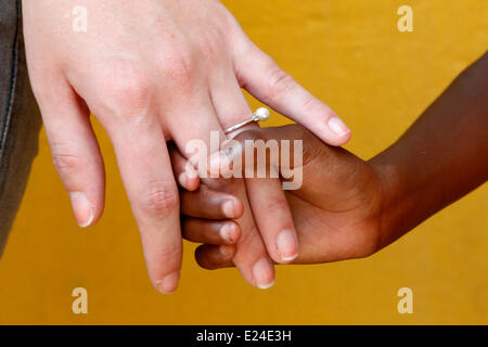 Adult giving a hand to an African child. Stock Photo