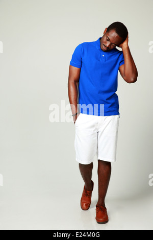 Studio shot of a pensive african man on gray background Stock Photo