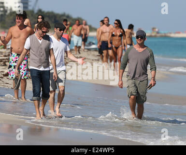 Gerard Butler enjoys a walk barefoot along Miami Beach accompanied by two male companions  Featuring: Gerard Butler Where: Miami Beach, Florida, United States When: 04 Feb 2013 Stock Photo