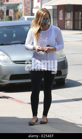 Hilary Duff carries her sleeping son Luca as they head to the Maxwell Dog store in Studio City  Featuring: Hilary Duff,Luca Comrie Where: Los Angeles, California, United States When: 26 Mar 2013 Stock Photo