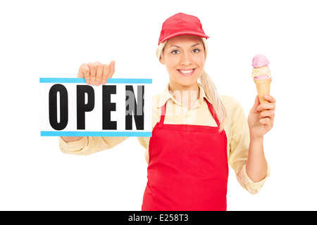 Female ice cream vendor holding an open sign Stock Photo