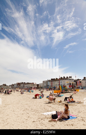 People sunbathing on Weymouth beach, in summer sunshine, Weymouth, Dorset England UK Stock Photo