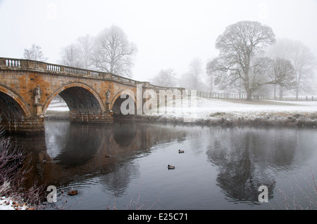Snow on the Derwent River at Chatsworth in the Peak District, Derbyshire England UK Stock Photo