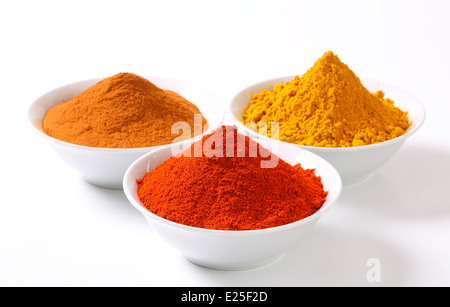 Bowls of curry powder, paprika and ground cinnamon Stock Photo