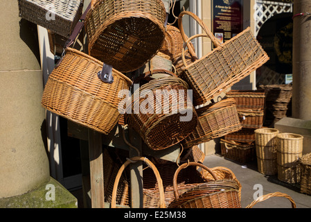 Wicker weave basket hanging up outside a shop in Bakewell Derbyshire England Stock Photo