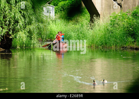 Three young boys learning to canoe. Stock Photo