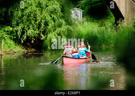 Three young boys learning to canoe. Stock Photo