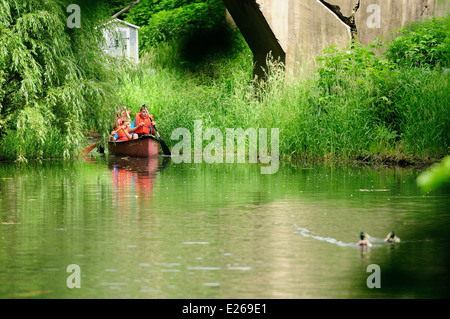 Three young boys learning to canoe. Stock Photo