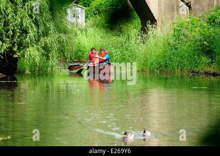 Three young boys learning to canoe. Stock Photo