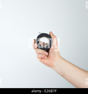 black Insulating tape in the hand Stock Photo