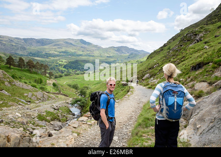 Two Millennial hikers descending lower slopes of the Watkin Path in Snowdonia National Park. Cwm Llan, Gwynedd, North Wales, UK, Britain Stock Photo
