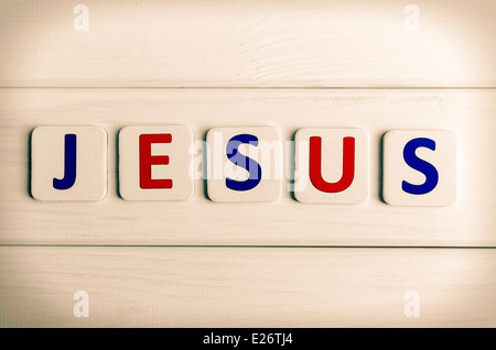 Jesus word composed of letters on a background of wood Stock Photo