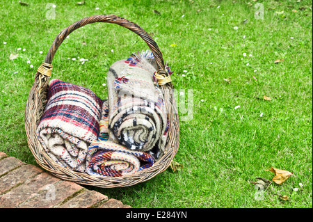 Rolled up wool blankets in a basket Stock Photo