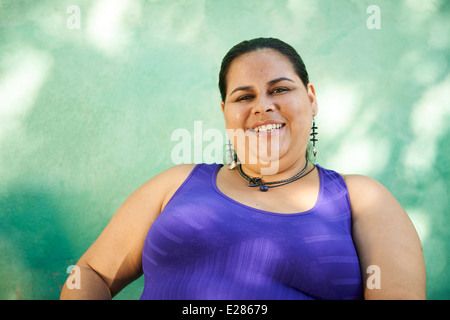 Portrait of overweight hispanic woman looking at camera and smiling Stock Photo