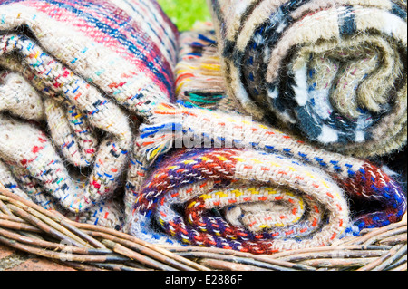Rolled up wool blankets in a basket Stock Photo