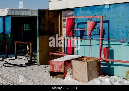 Colourful Fire buckets Russian petrol station sun Stock Photo