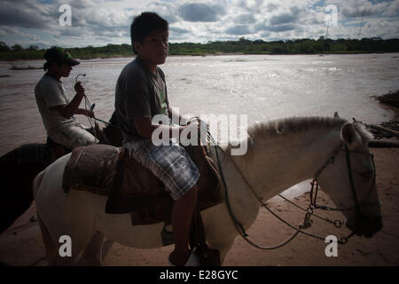 Childen ride horses at the site known as Las Cabanas del Rio Pirai