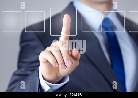 Businessman pushing on a touch screen interface Stock Photo