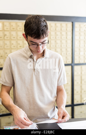 College student checking mail at mailboxed Stock Photo - Alamy