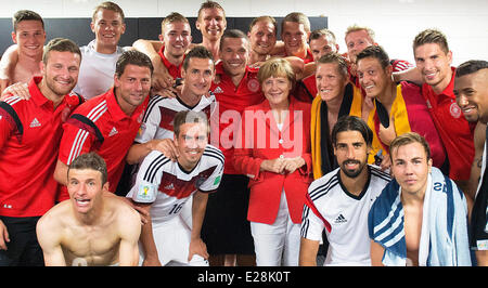 Salvador, Brazil. 16th June, 2014. HANDOUT - A handout picture made available on 16 June 2014 shows German Chancellor Angela Merkel (C) visiting the German national soccer team in their locker room after their victory of the FIFA Worl Cup mach against Portugual in Salvador, Brazil. Credit:  dpa picture alliance/Alamy Live News Stock Photo