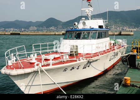 Small Japanese coast guard boat / ship in harbour / harbor. Shimonoseki Port, Seto Insland Sea / Kanmon Straits Stock Photo