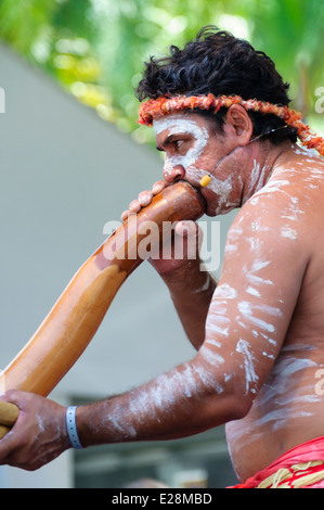 Australian Aborigine man in body paint playing a didgeridoo; Aboriginal culture; native Australian; Australia; traditional musical instrument; Stock Photo