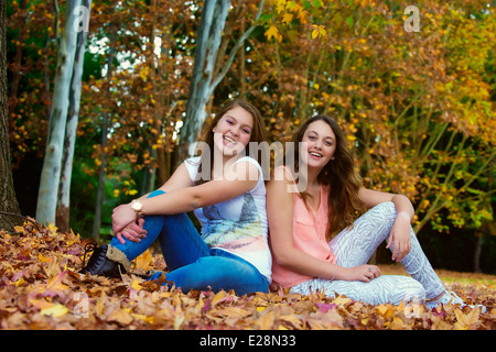 Young teenage girl friends laughing in the park Stock Photo