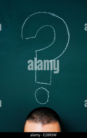 a man over a blackboard with a question mark drawn in it Stock Photo