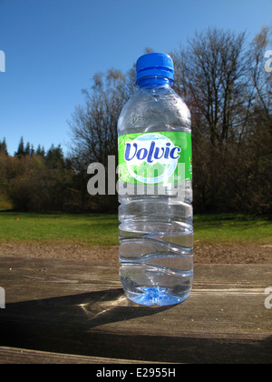 Backlit bottle of Volvic mineral water outside in sun Stock Photo