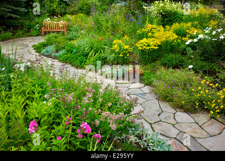 Flower garden with foreground sedums and stone path in Betty Ford Alpine Gardens. Vale Colorado Stock Photo