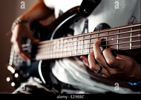 Girl Playing Bass guitar Stock Photo