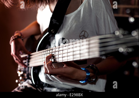 Girl Playing Bass guitar Stock Photo