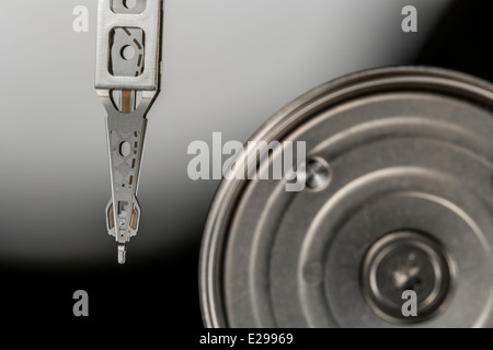 Macro photo of HDD read-write head and arm resting over disk platter. See 'description' for full detail of image focus point. Abstract data. Stock Photo