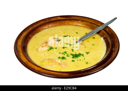 bowl of freshly cooked hearty pea and ham soup sprinkled with chopped parsley Stock Photo