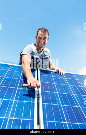 Professional installing electric solar panels Stock Photo