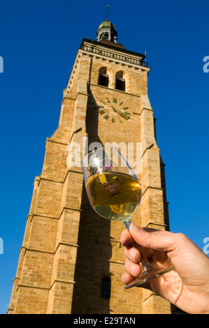 France, Jura, Arbois, breakthrough of the yellow wine, glass of yellow wine, bell tower of the church Saint Just Stock Photo