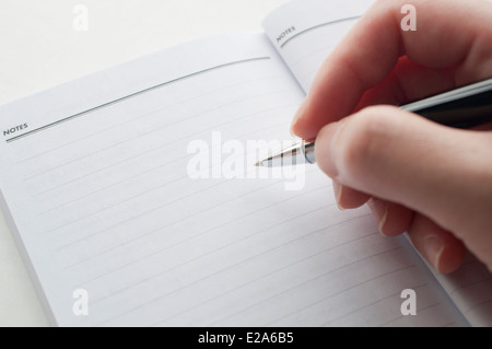 Close up woman's hand taking note Stock Photo