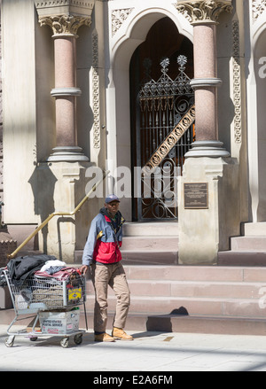 homeless man pulling trolley with belongings, Philadelphia, Pennsylvania, USA Stock Photo