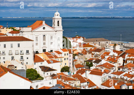Portugal, Lisbon, view over the rooftops of the Alfama district, the church Santo Estevao and the Tage river from the terrace