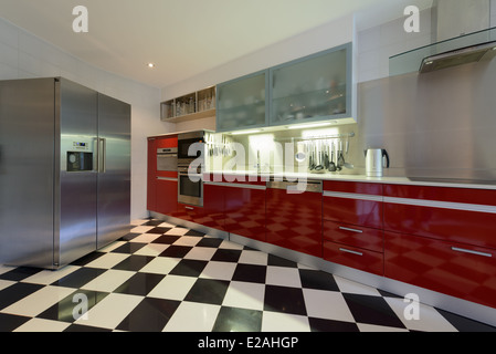 Interior of modern kitchen with red fridge, counters and pegboard Stock ...
